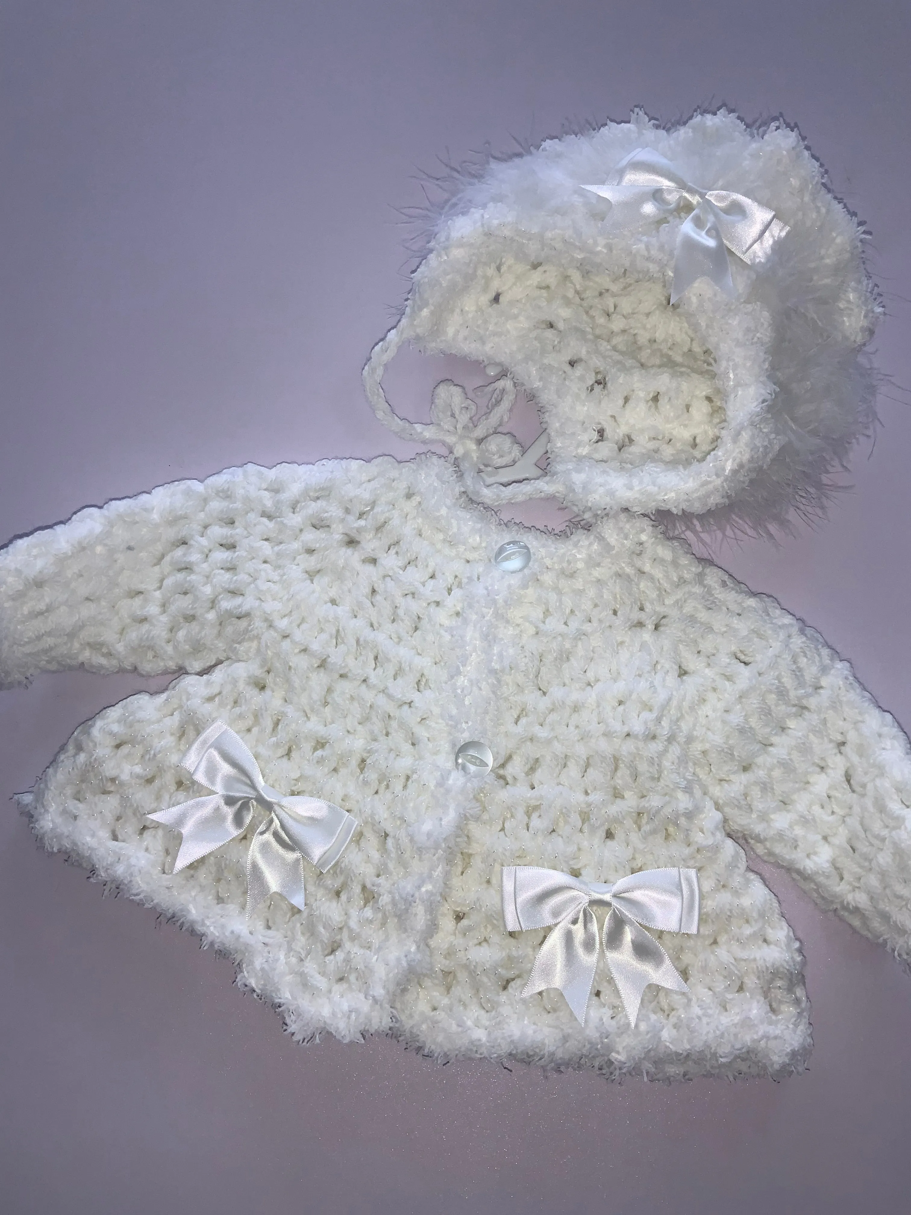 Crocheted cardigan and bonnet 06242344